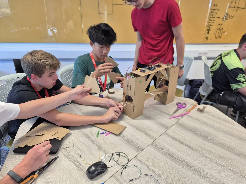 Engineering participants building a cardboard robotic arm