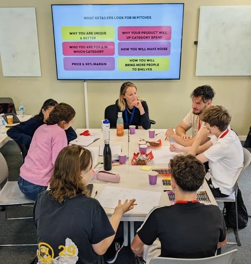 A business mentor working with participants on what retailers look for in a pitch
