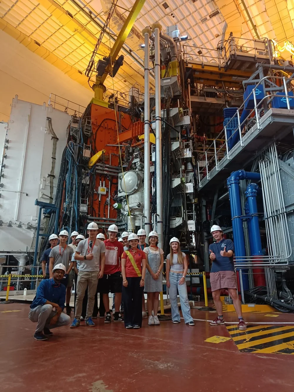 Engineering participants in hard hats at a fusion research facility