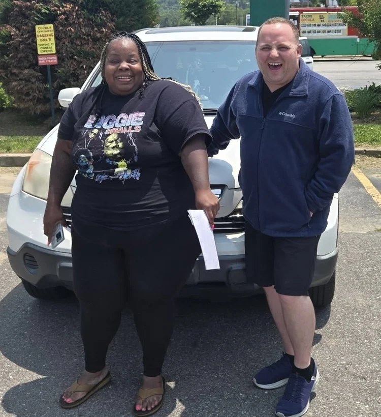 Parent with mechanic they are picking up vehicle after being repaired. 