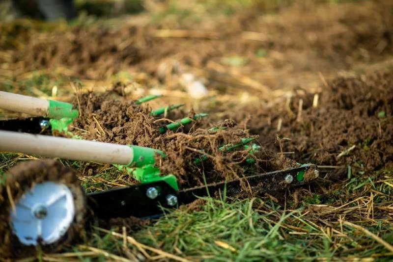 Lawn aerator pulling soil plugs