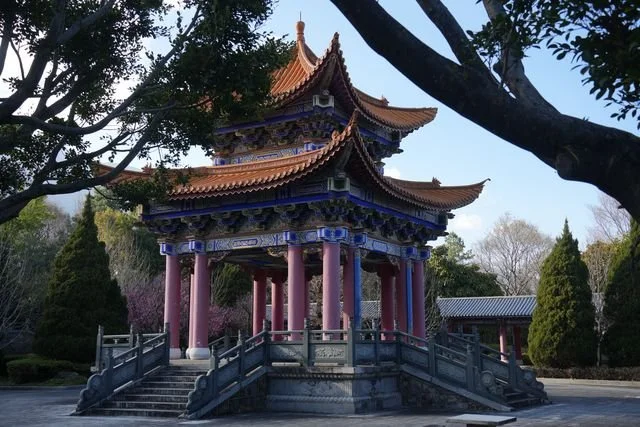 Trees frame an ornate pavilion in the grounds of Dali's Three Pagodas.