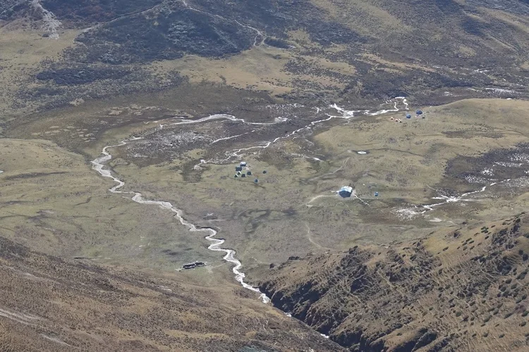 Tongphushong Camp appears far below, its small tents beside the winding stream.