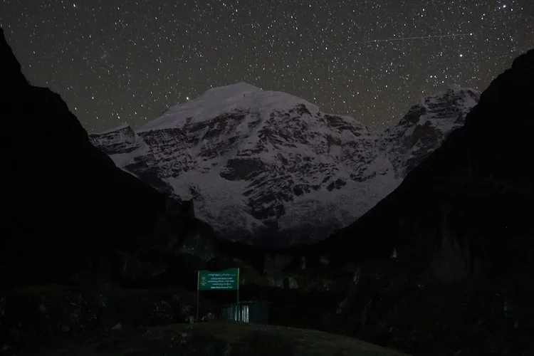 A closer night view reveals the snow and dark rock bands across Chomolhari’s face.