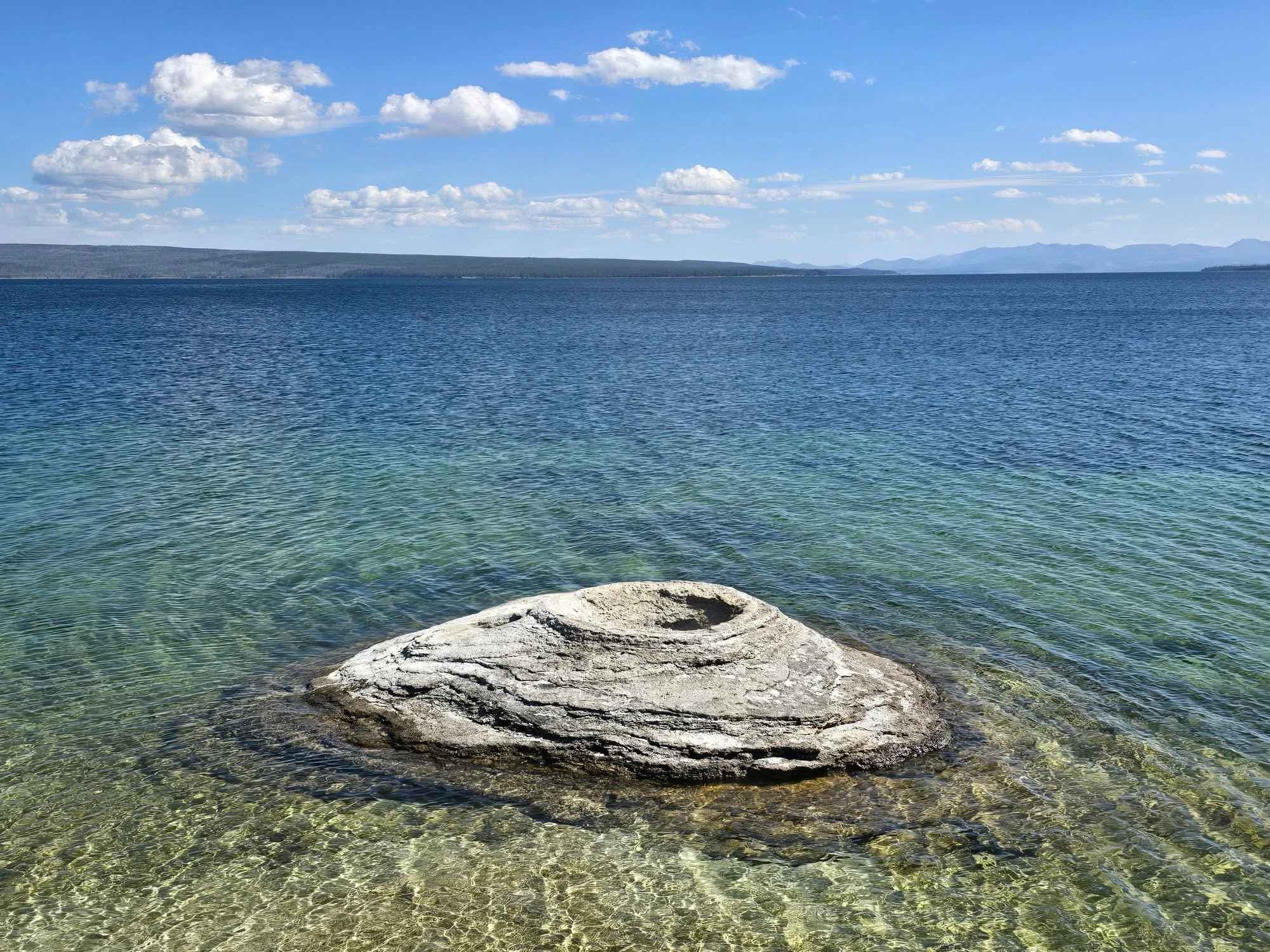 Fishing Cone rises from the clear shallows of Yellowstone Lake.
