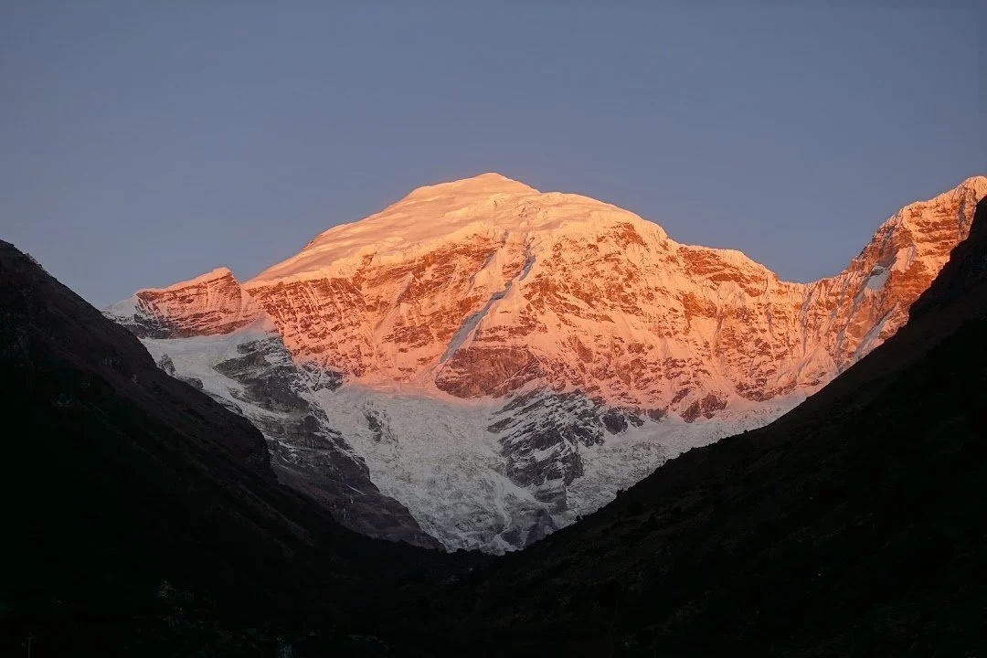 The first light turns Chomolhari’s upper snowfields orange while its glacier remains in shadow.