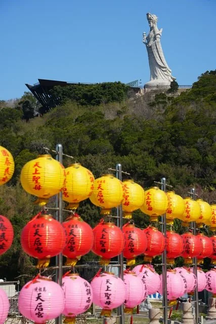 Yellow, red and pink lanterns fill the foreground beneath Nangan's Mazu statue.