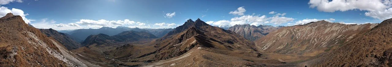 A broad panorama from the ridge near Takulungla Pass, with valleys falling away on both sides.