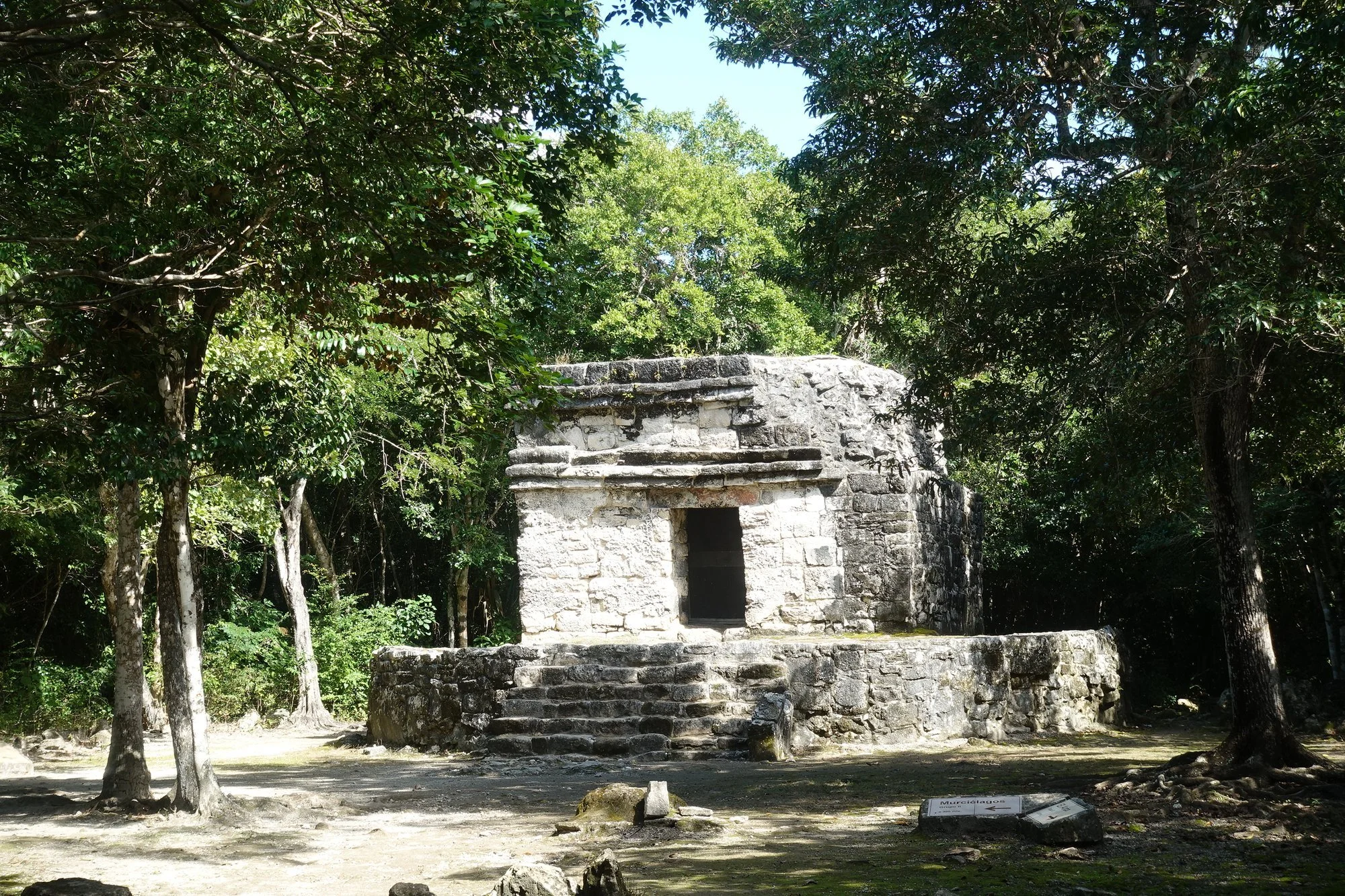 A small stone temple stands in a forest clearing at San Gervasio, Cozumel.