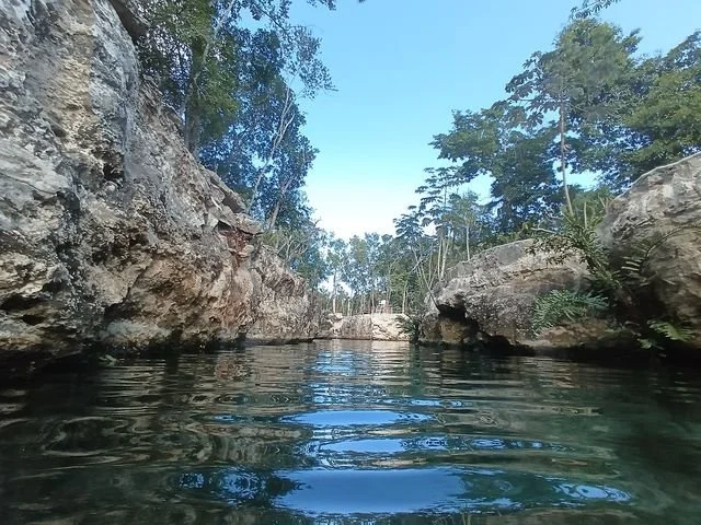At water level, limestone walls frame an opening to the sky.