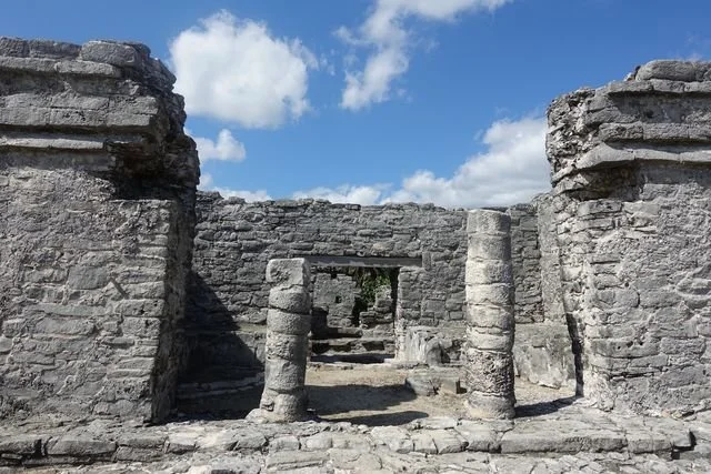 Round stone columns frame a succession of doorways at Tulum.