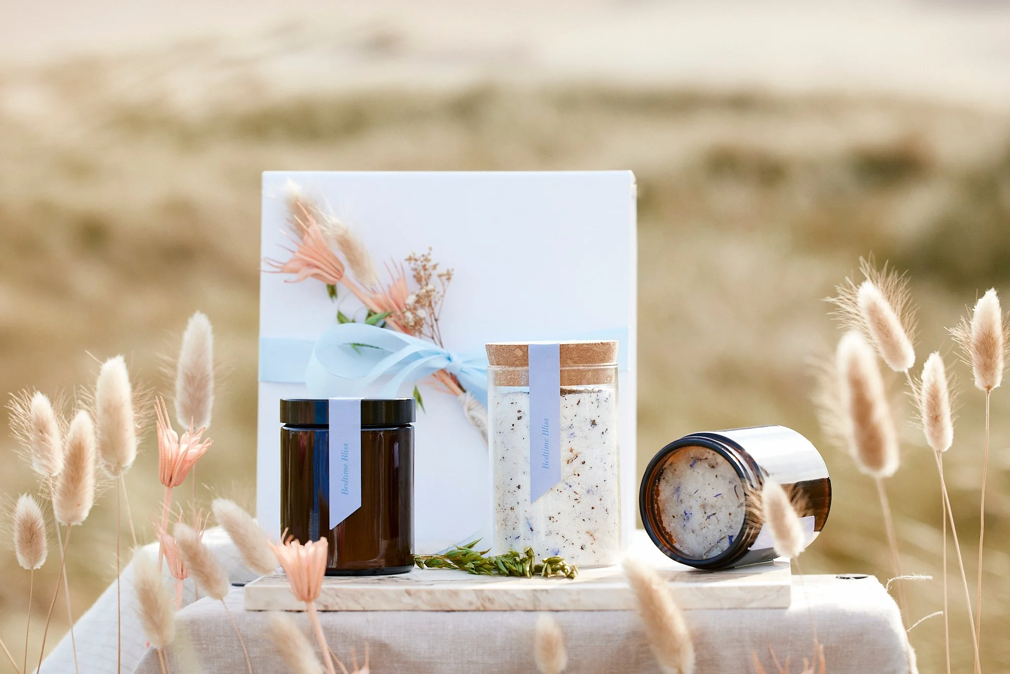 The Bedtime Bliss bath ritual laid out on a table above the dunes