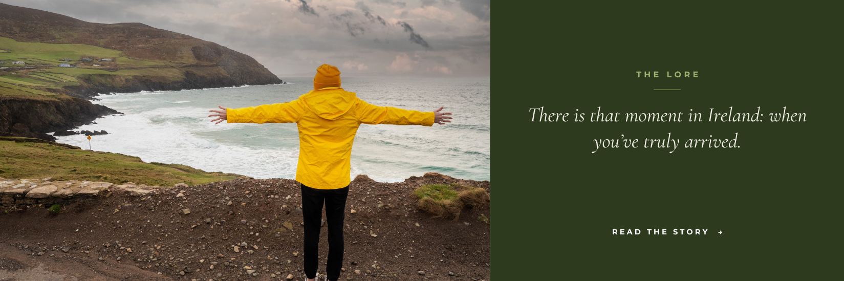 A figure in a yellow raincoat standing above a beach on the Atlantic coast, arms outstretched