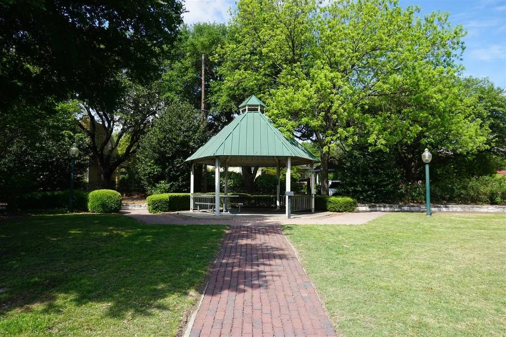 Gazebo and brick path under live oaks at a McKinney, Texas park