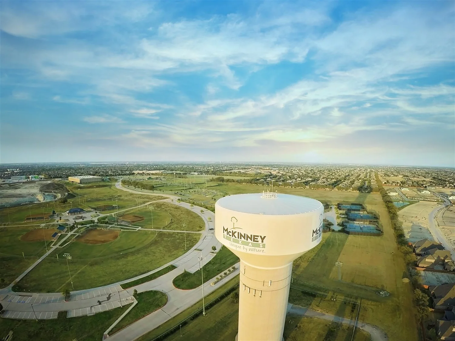 Aerial view over north McKinney, Texas, with the city water tower, ball fields and new neighborhoods