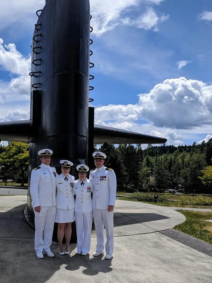 Navy officers white uniforms by submarine sail
