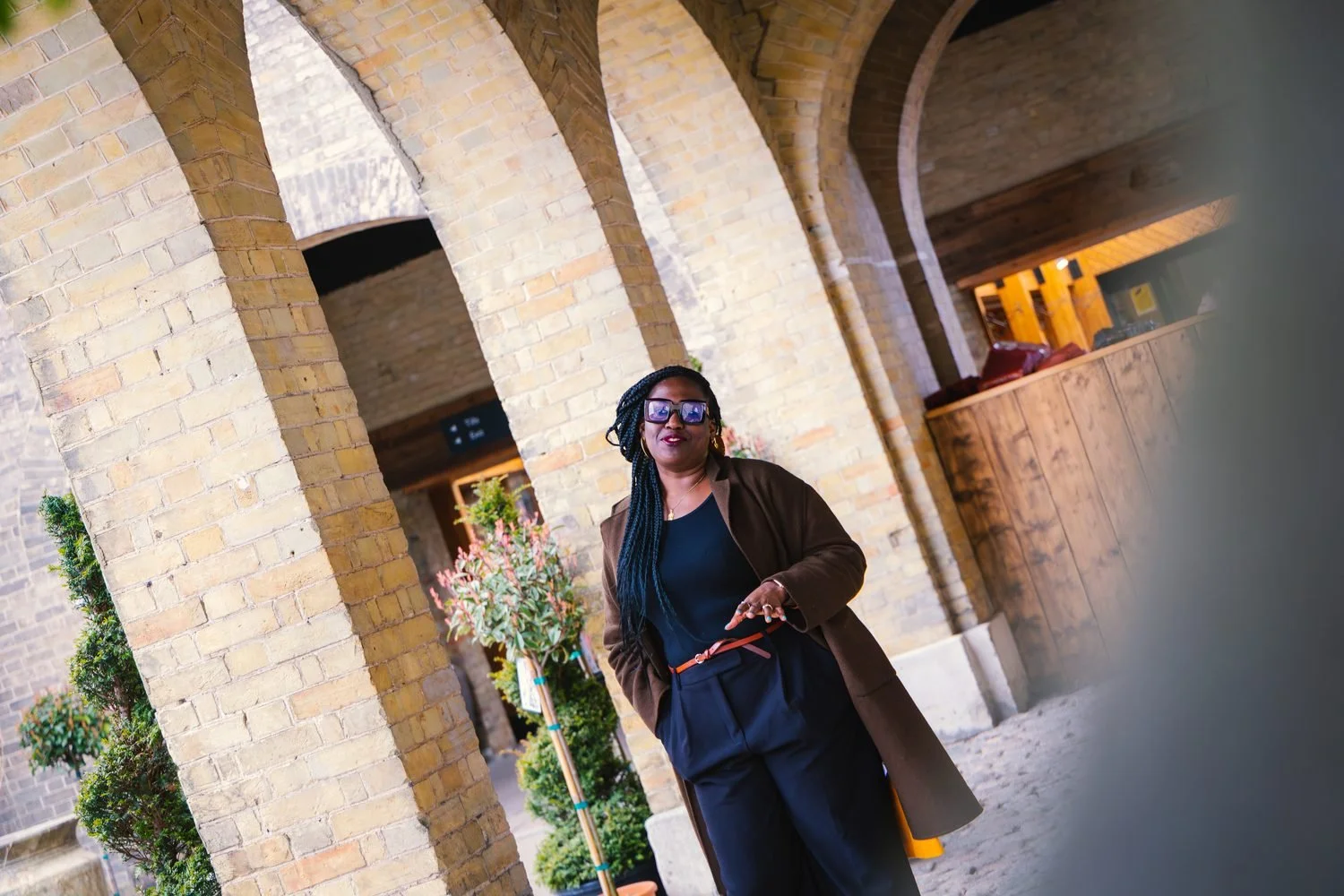 Timi Phillips walking through brick arches in London