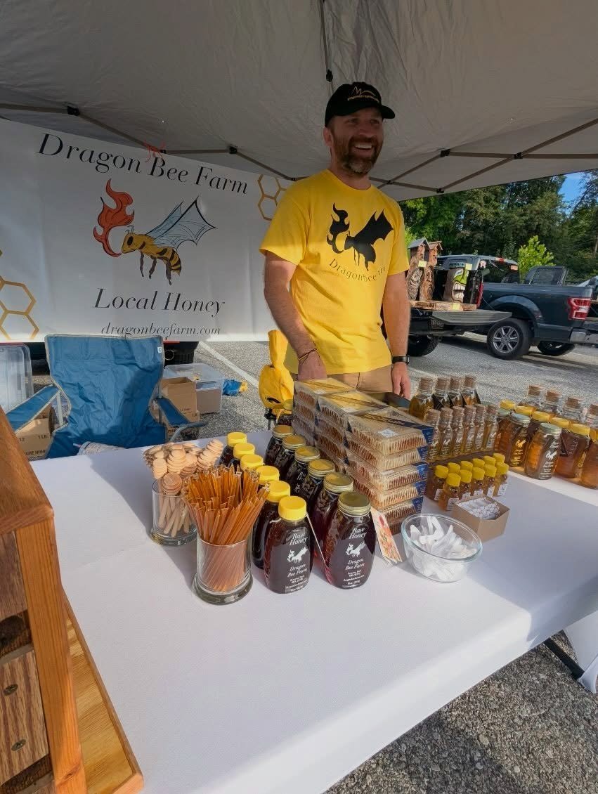 Dragon Bee Farm raw honey jars and honey bears on the market table