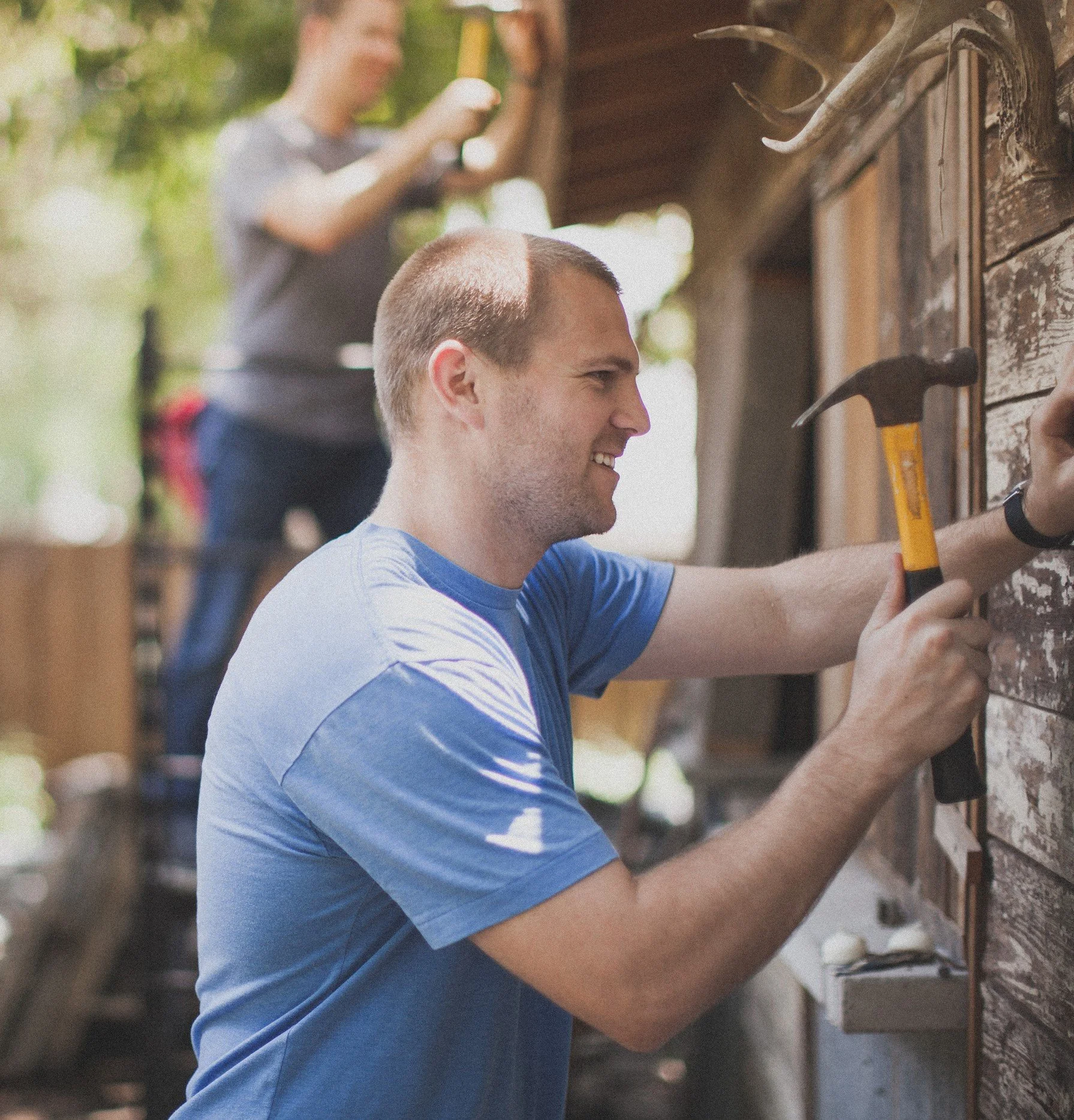 A Ukrainian man hammering a nail into a new house.