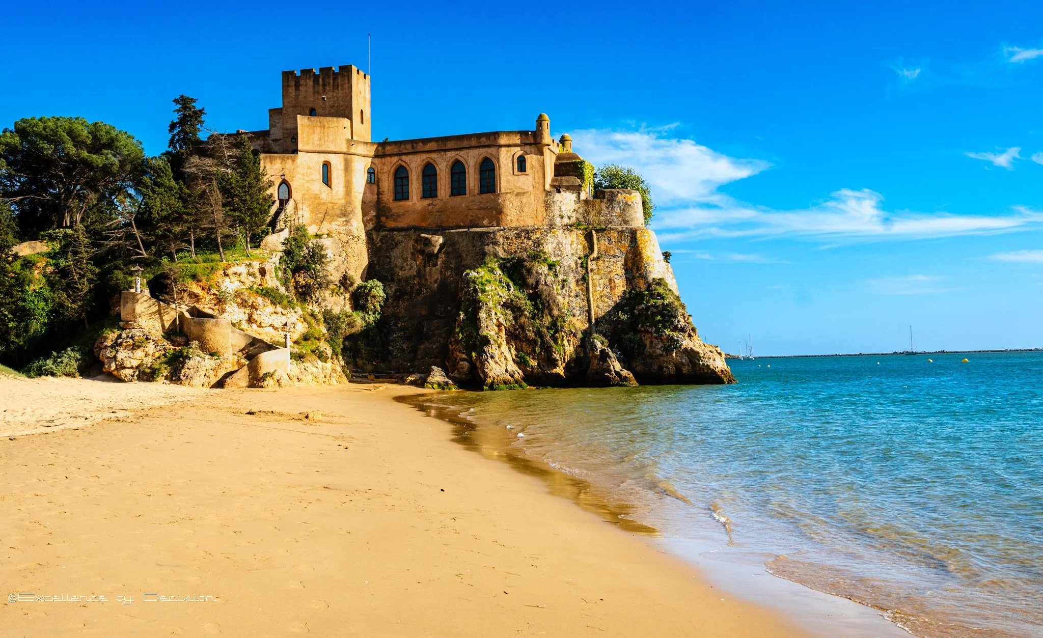 Algarve luxury travel guide hero image with coastline and castle