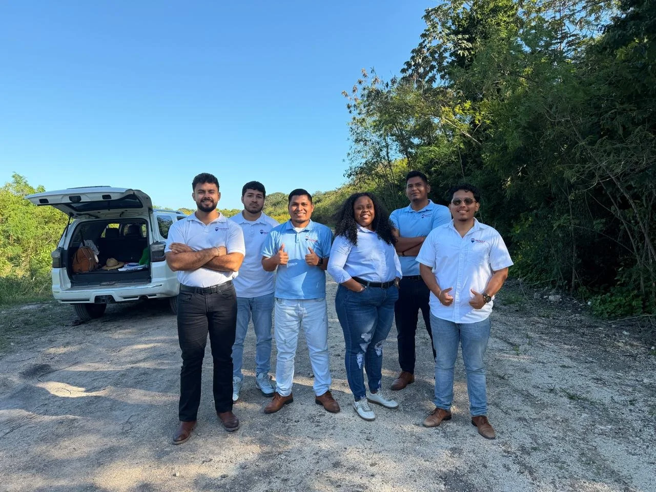 Members of the Coastal Vista team standing on a cleared lot in the Phase 2 subdivision