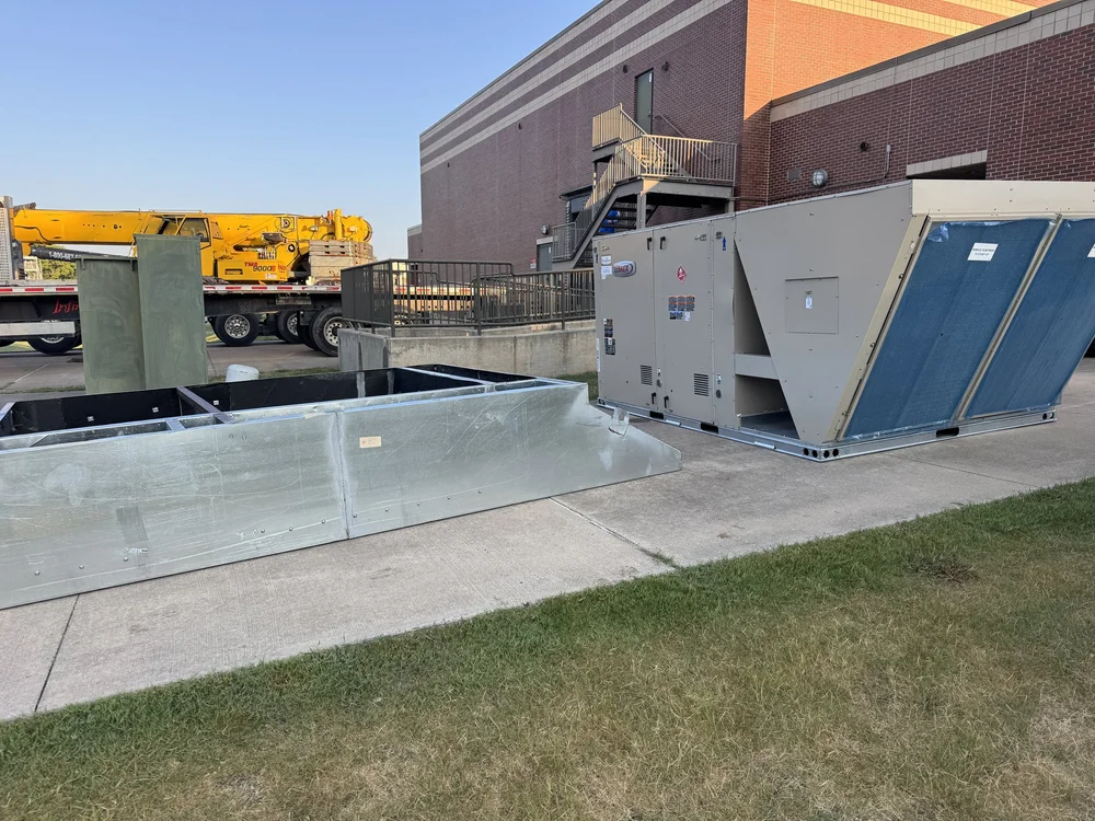Commercial ductwork and rooftop units staged for a Clark HVAC install at a school in Greenwood, AR