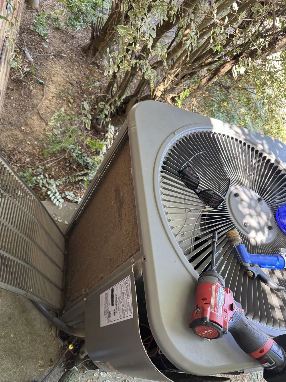 Clark HVAC technician replacing the condenser fan motor on an AC unit on a service call near Alma, AR
