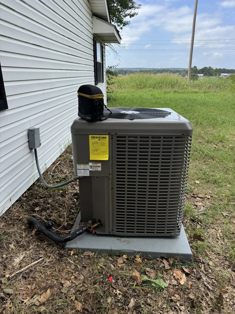 The worn-out AC condenser at a mobile home near Keota, OK, before Clark HVAC replaced it