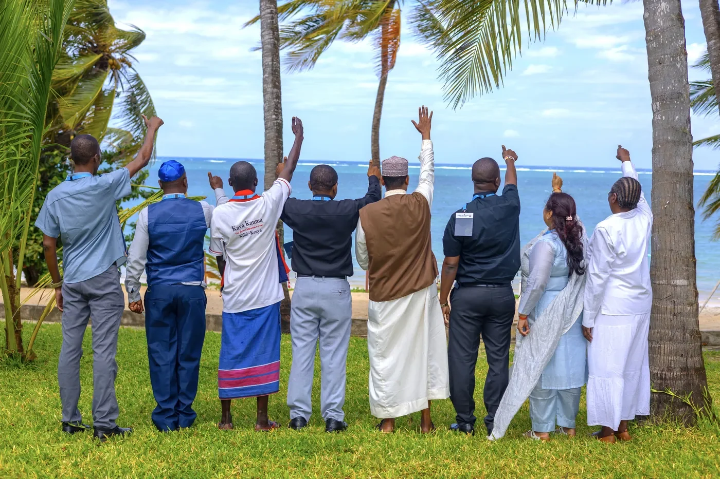Faith leaders on the Kenyan coast raise their hands towards the Indian Ocean.
