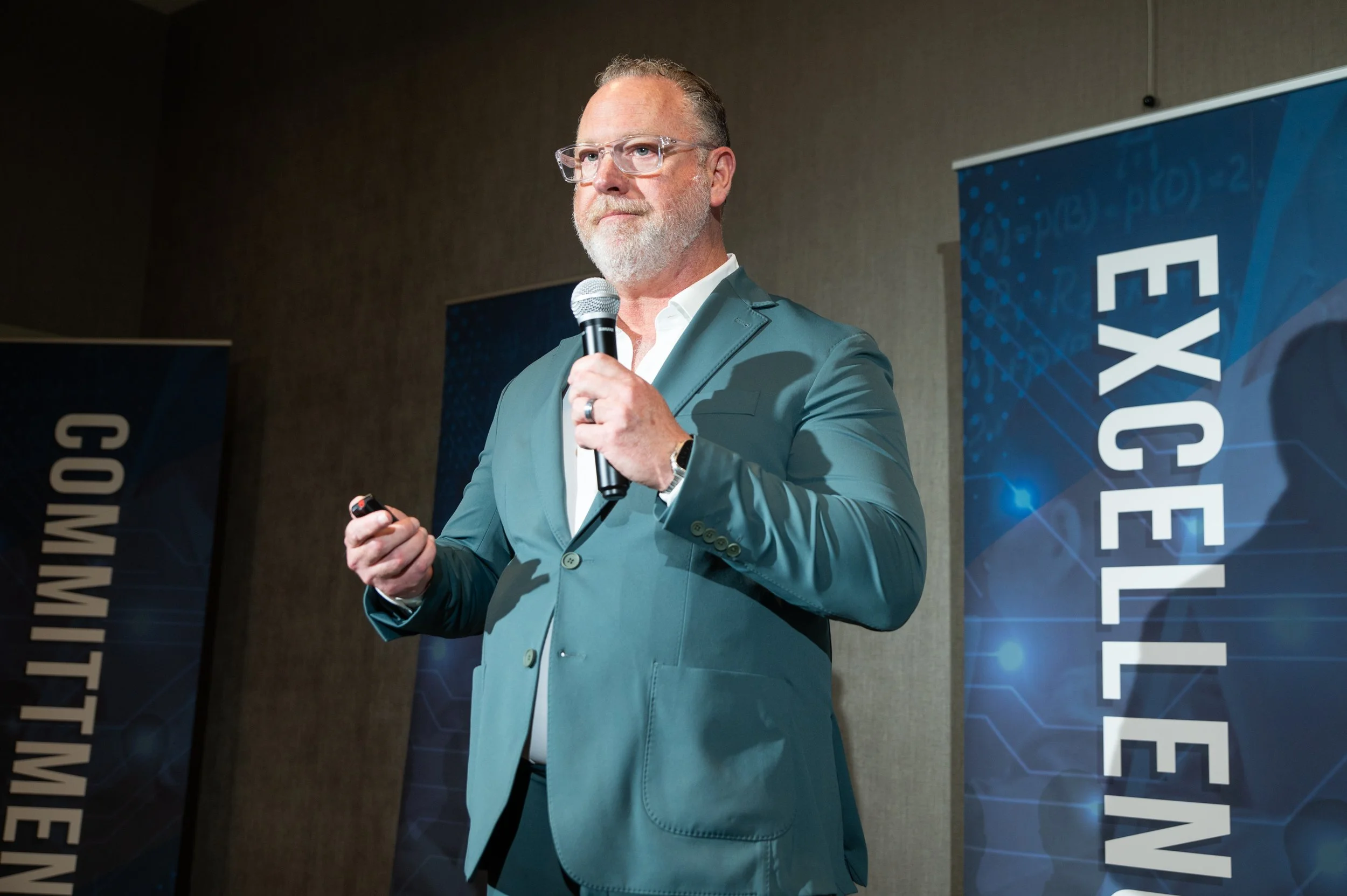 Scott Reib speaking in front of a Shatterproof banner