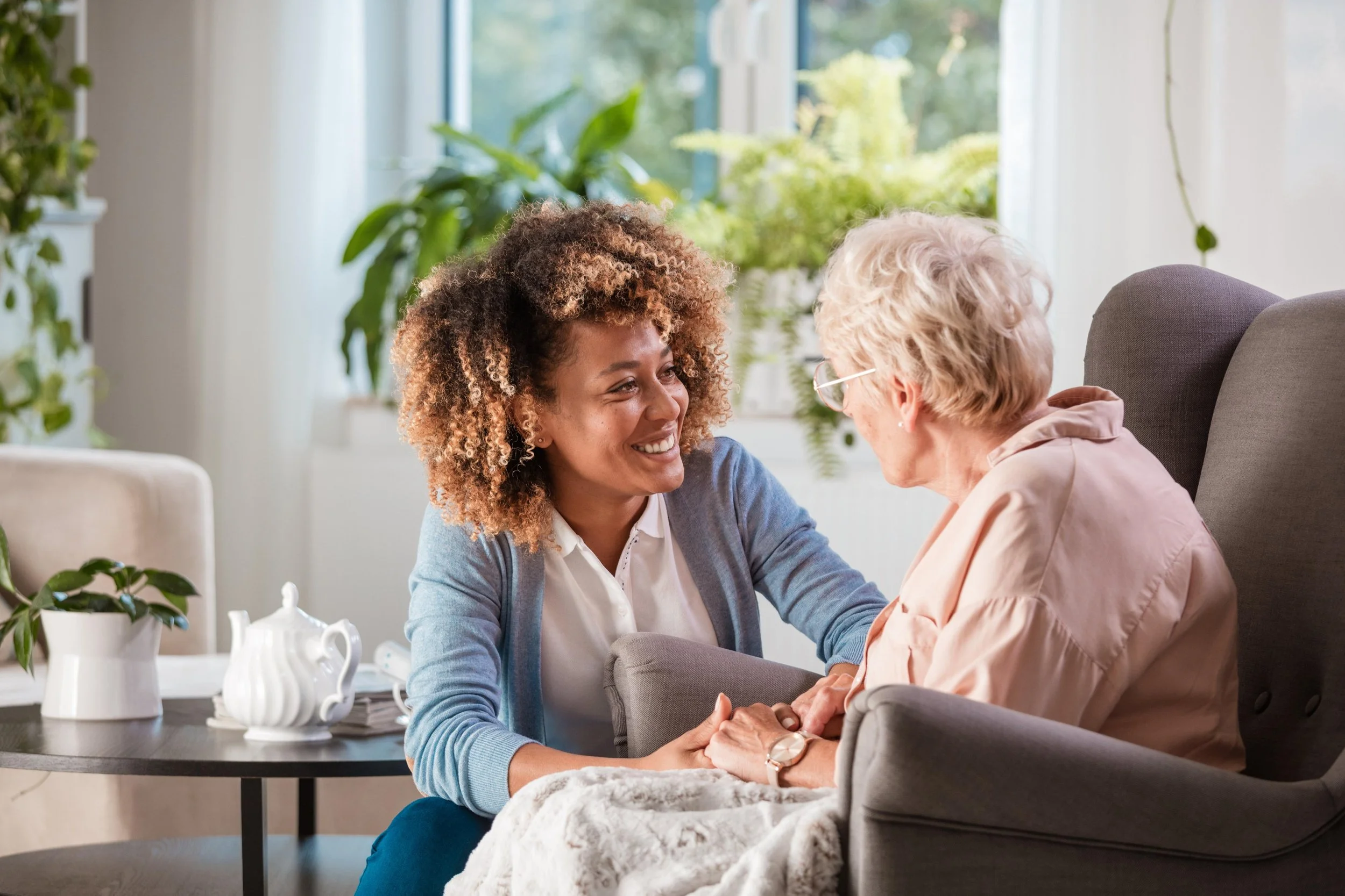 SILK caregiver listening attentively to an older woman at home