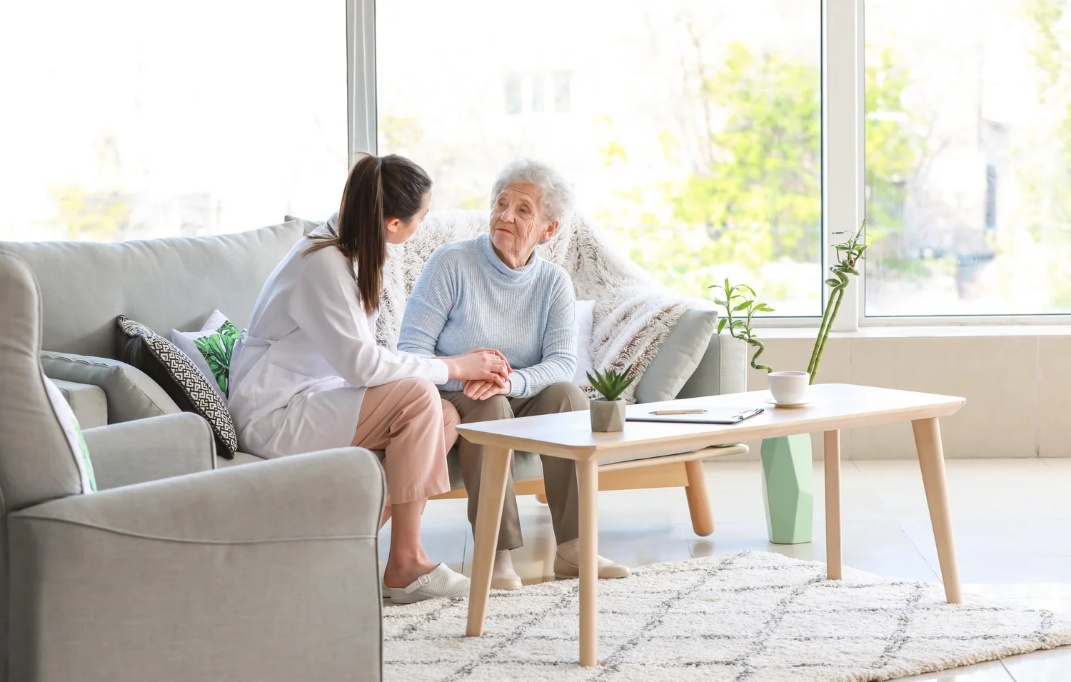 Care professional listening to an older adult at home