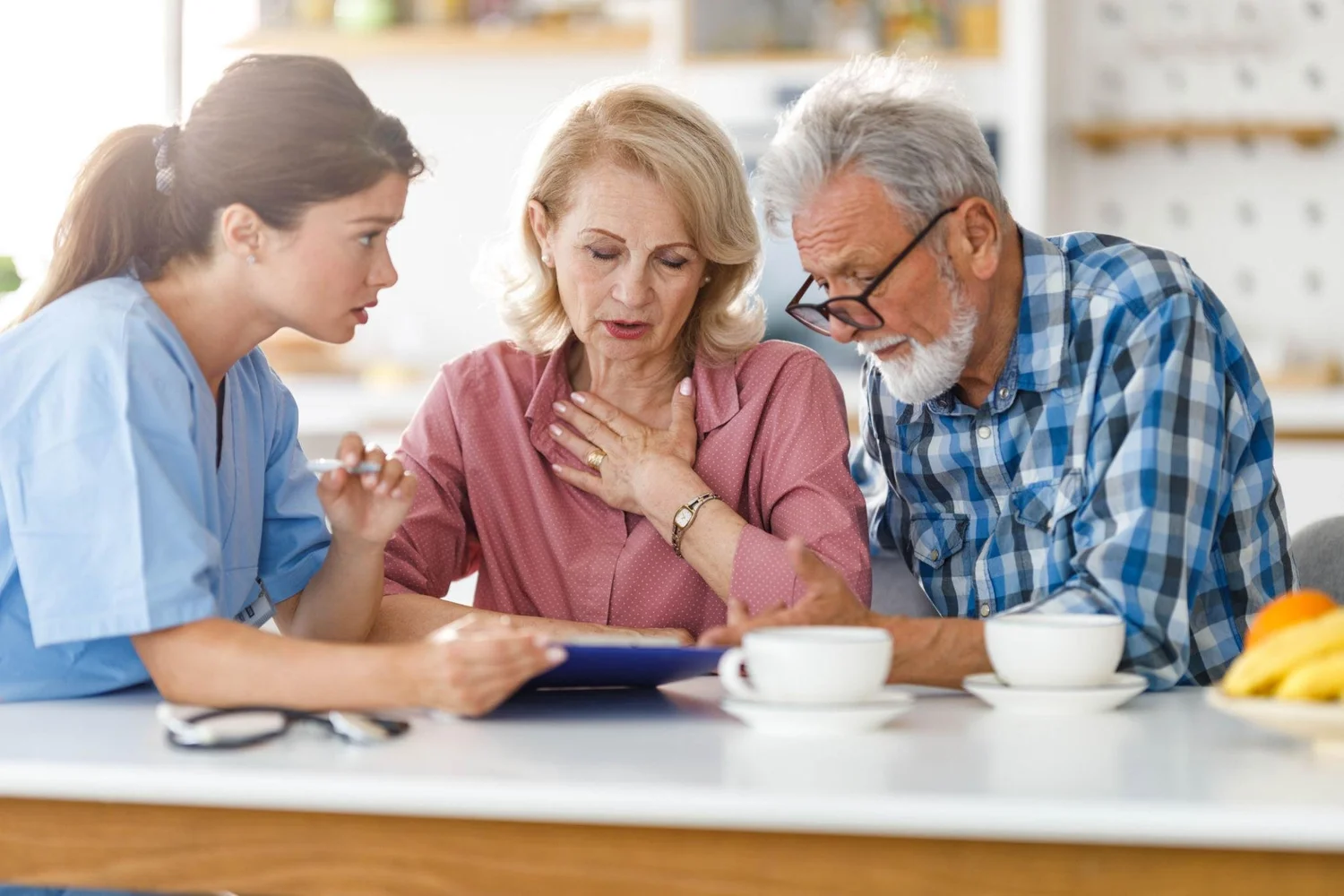 Care professional discussing a support plan with an older couple