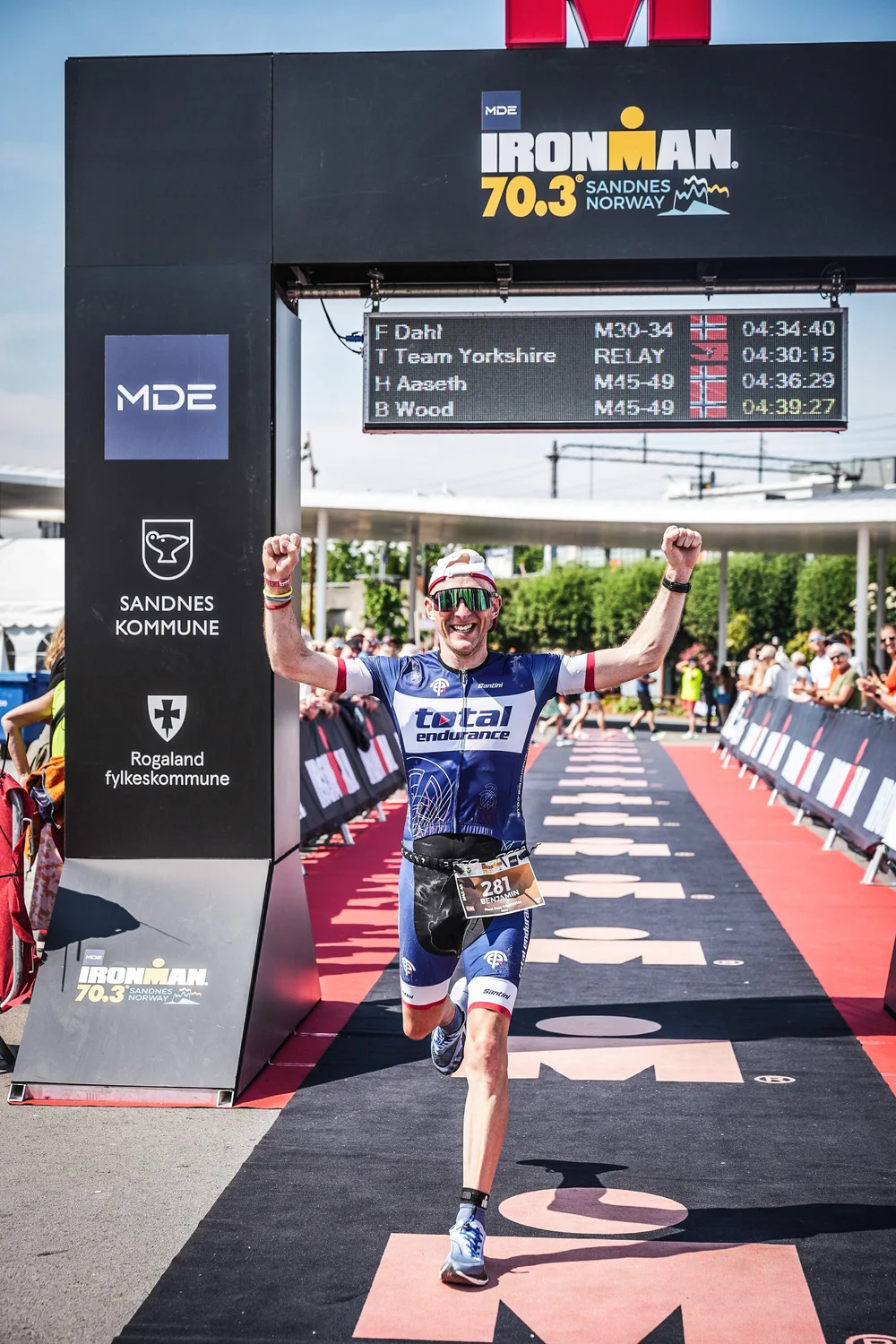 Ben Wood crossing the finish line at IRONMAN 70.3 Sandnes in Total Endurance kit