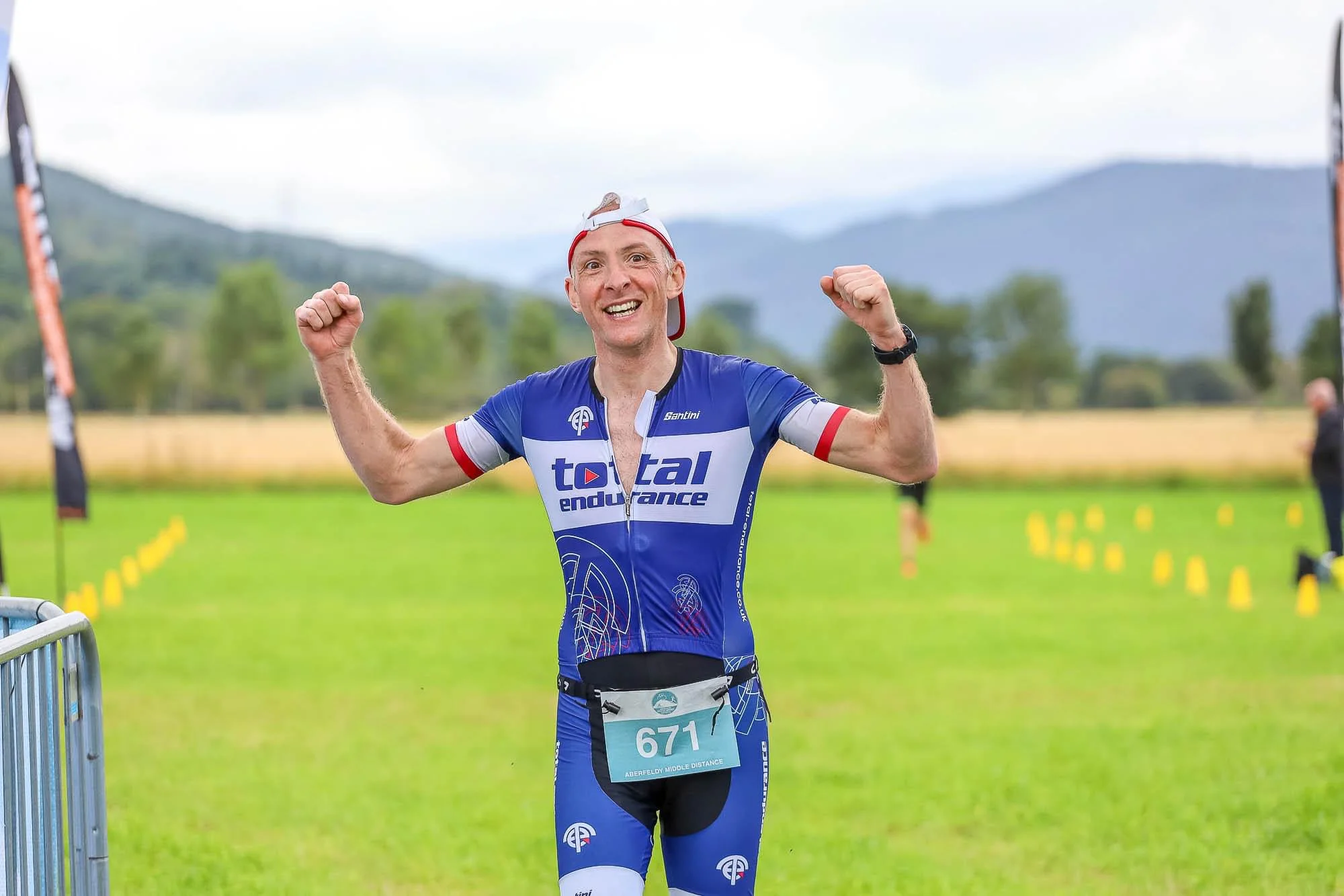 Ben Wood, Total Endurance athlete, celebrating at the finish of the Aberfeldy Middle Distance triathlon