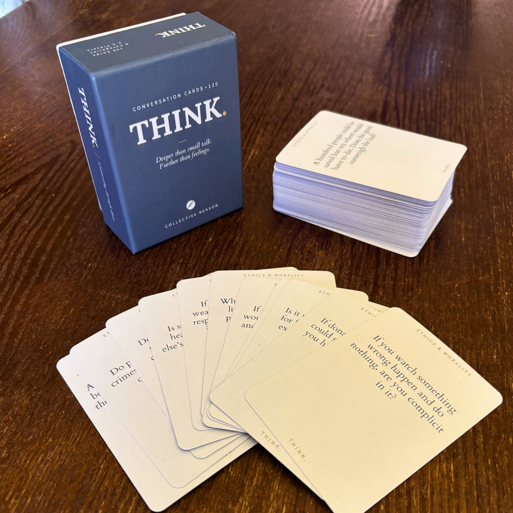 THINK. conversation cards spread out on a table, an ethics question face-up