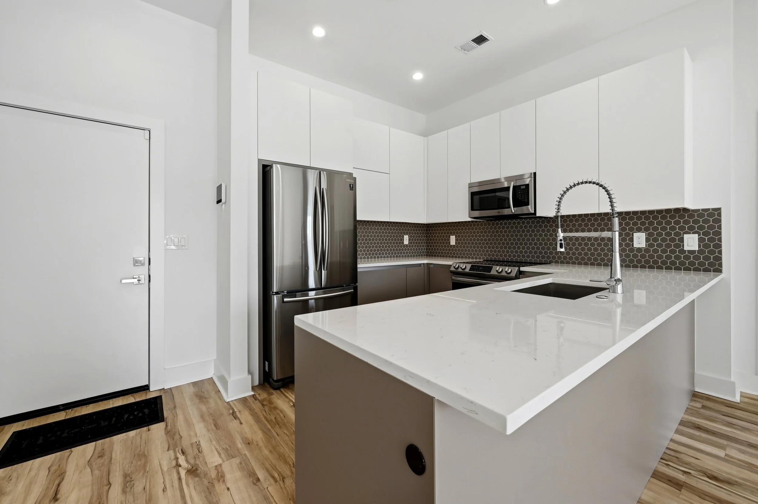 Kitchen with quartz countertops and stainless appliances at Moreland Walk #202