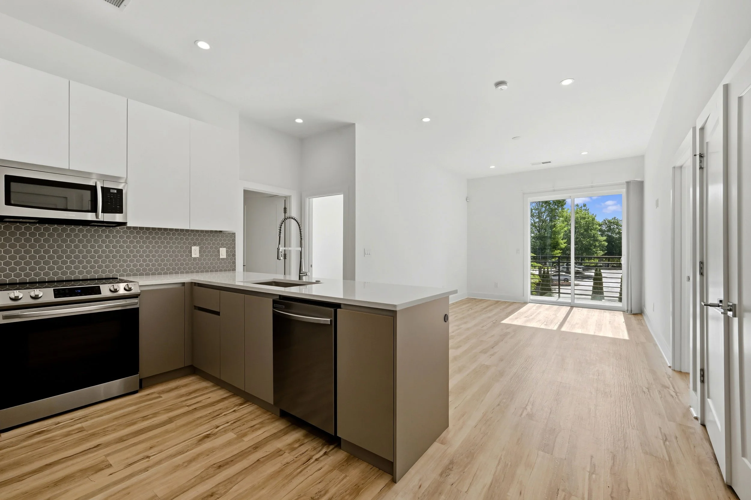Open-concept living and kitchen area at Moreland Walk #202