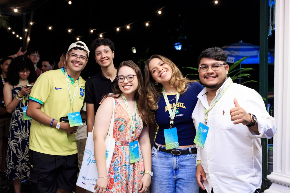 A group of alumni posing together at an evening event