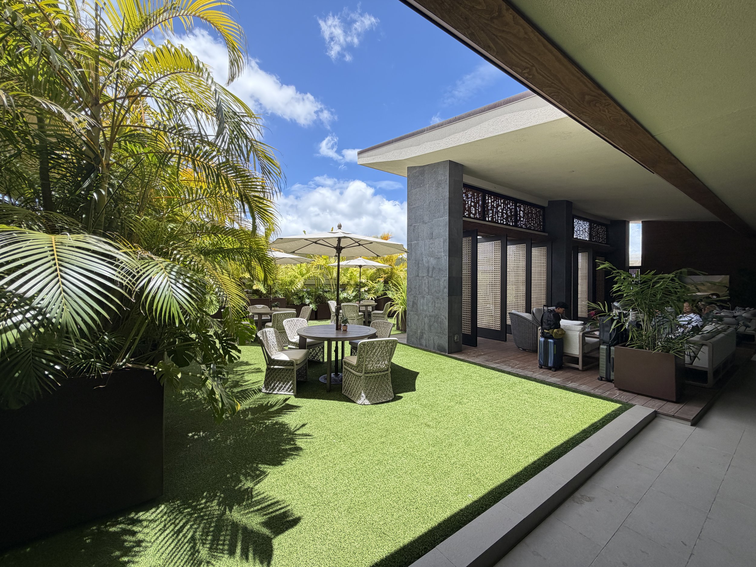 Seating area inside The Plumeria Loft lounge at HNL