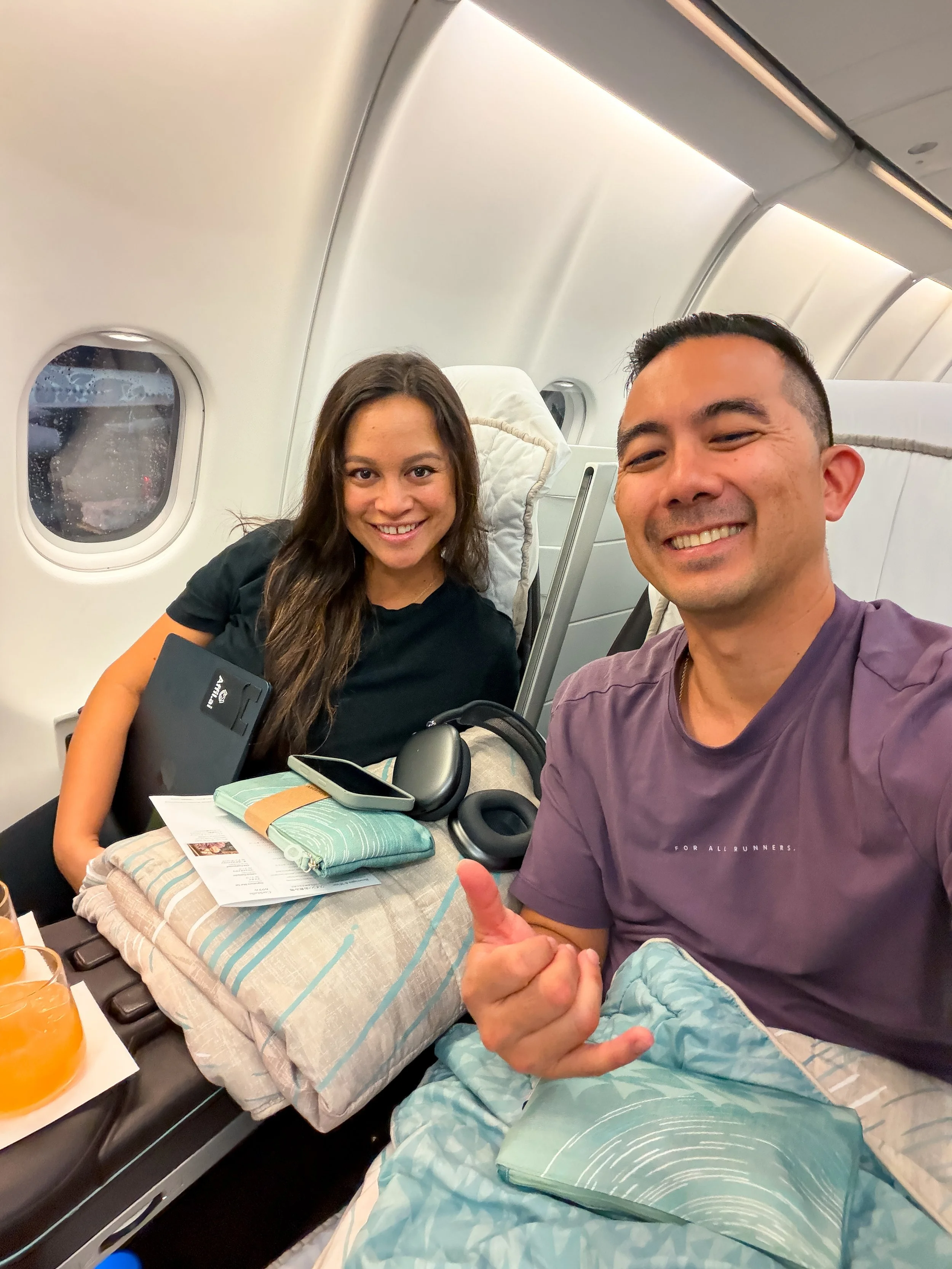 Japan Airlines business class cabin on a flight to Tokyo booked with transferred Capital One miles