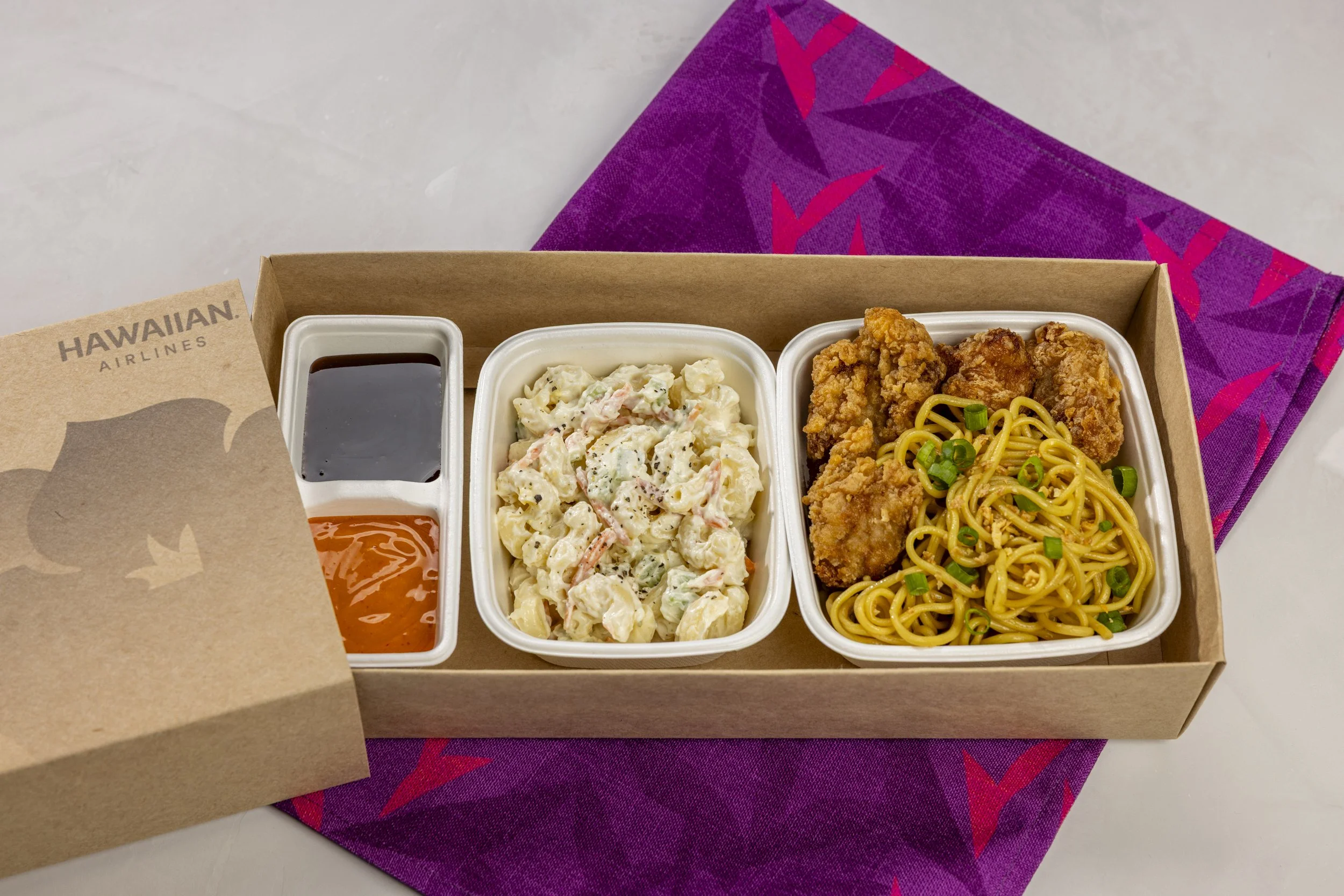 Close-up of crispy mochiko chicken over garlic noodles