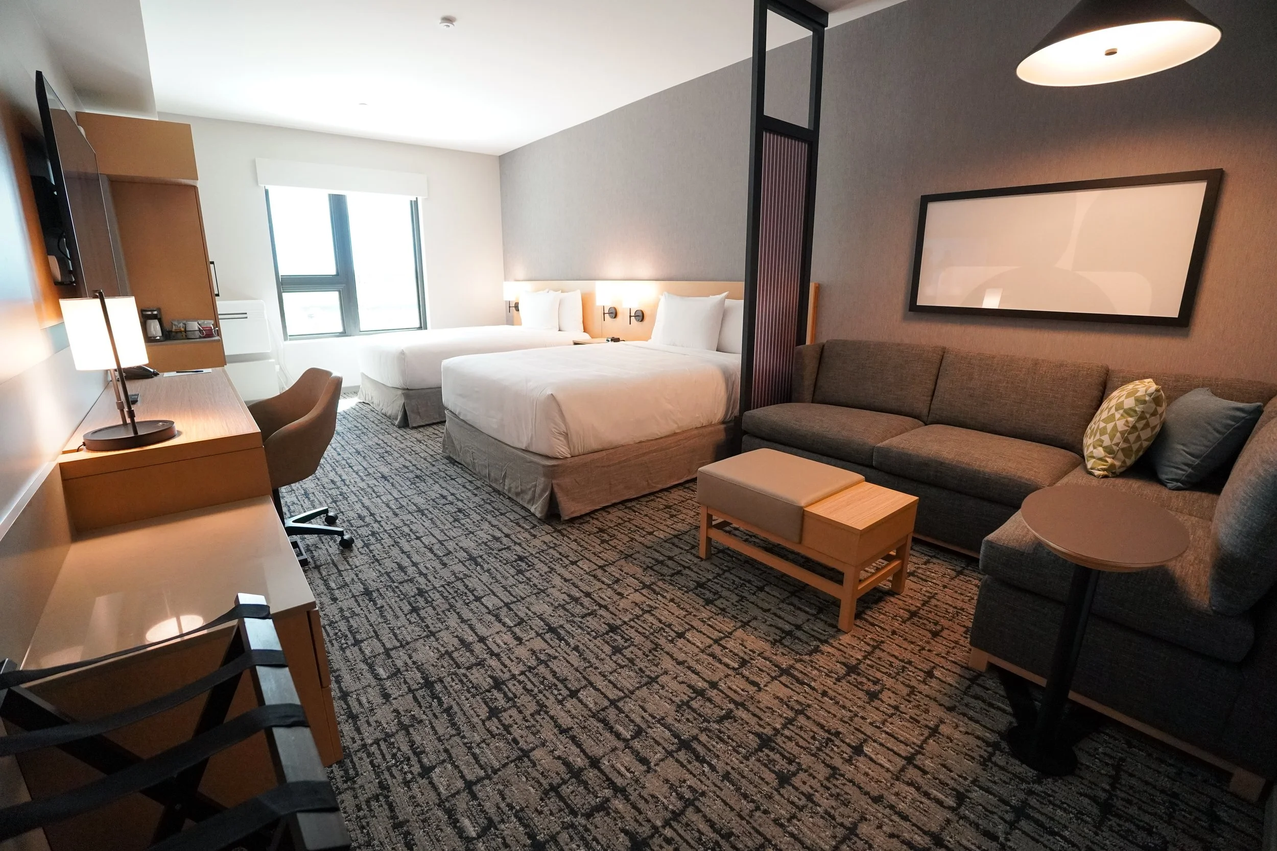 Spacious brand-new guest room at Hyatt House Hoʻopili with bed and seating area
