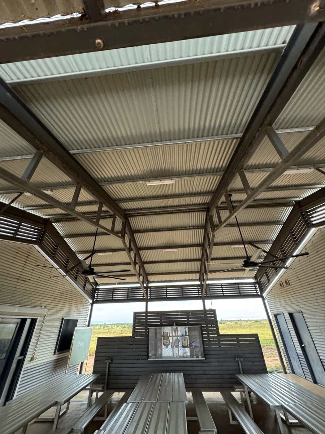 Lighting and ceiling fans in an open-sided community shelter