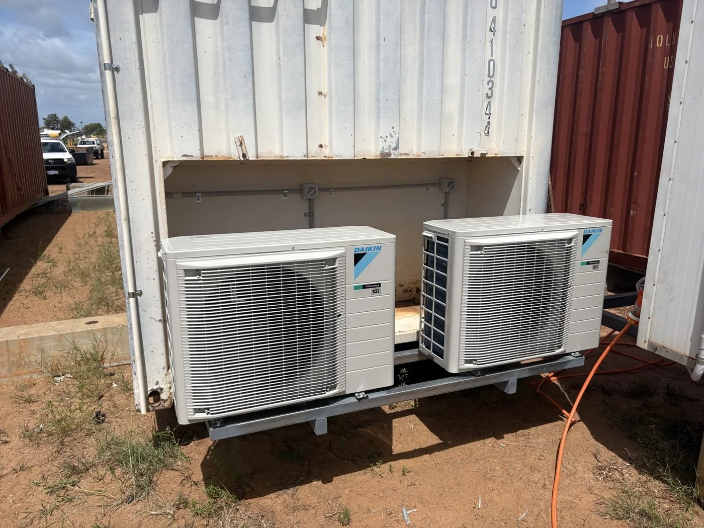 Twin Daikin condensers installed on a remote site building