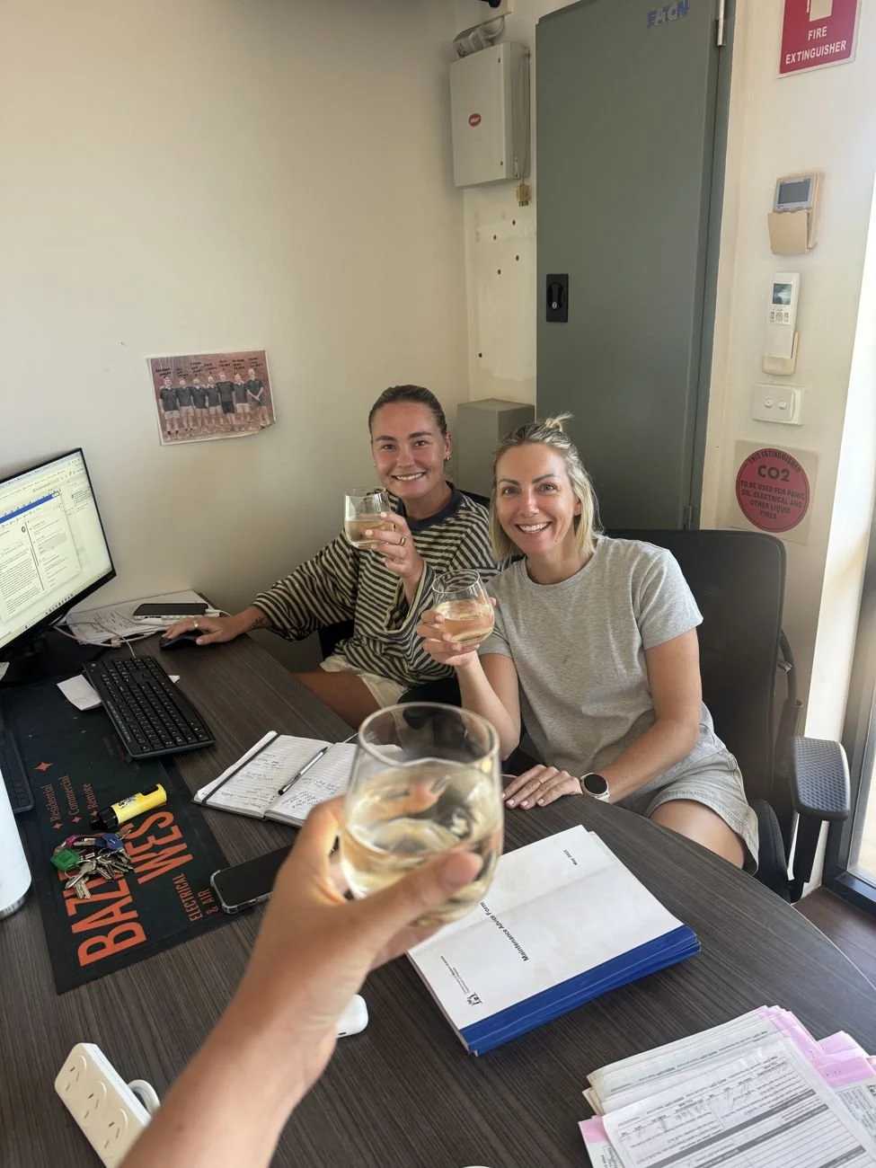 The office team raising a glass at their desks