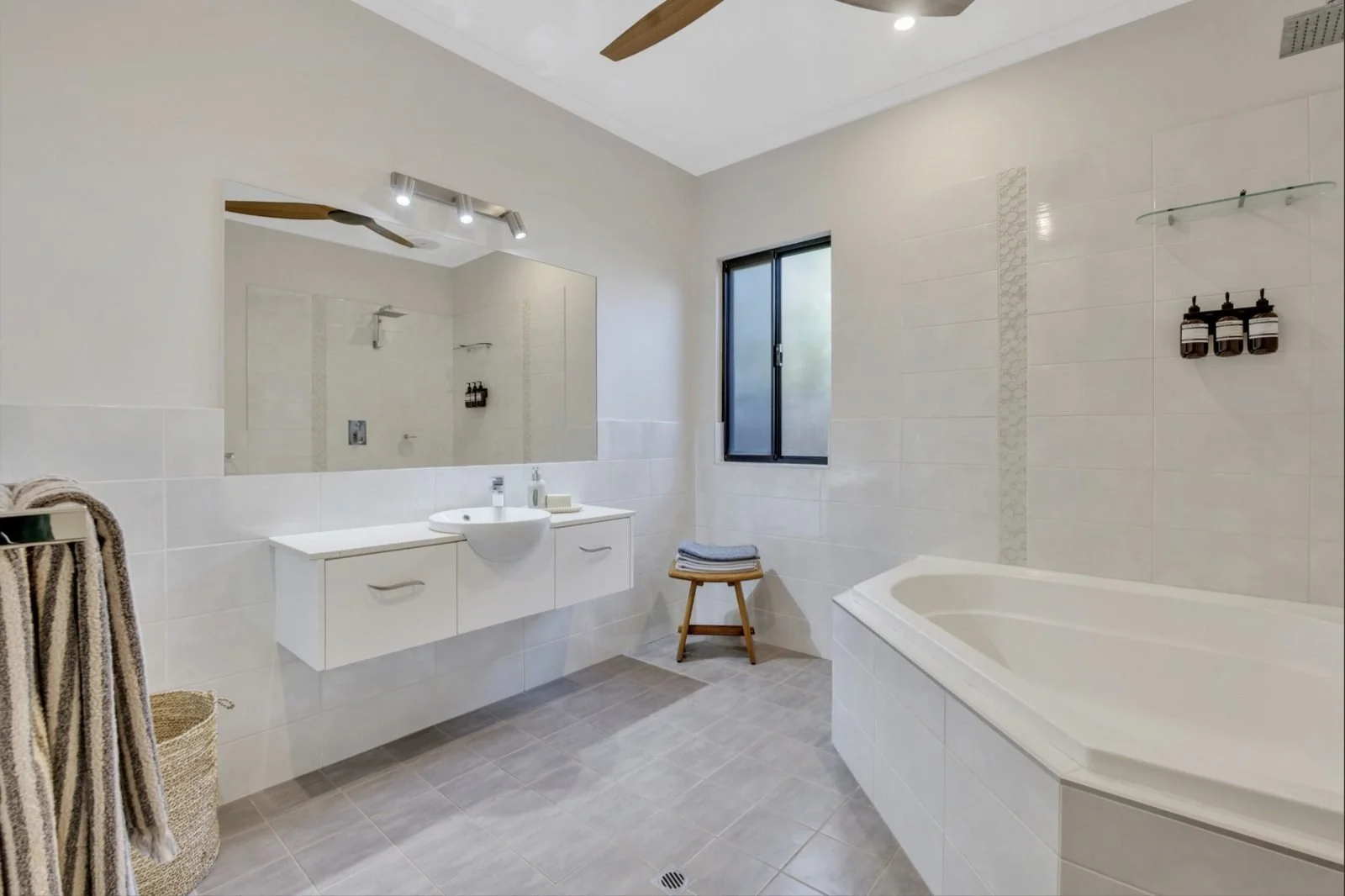 Bathroom with vanity lighting, downlights and ceiling fan