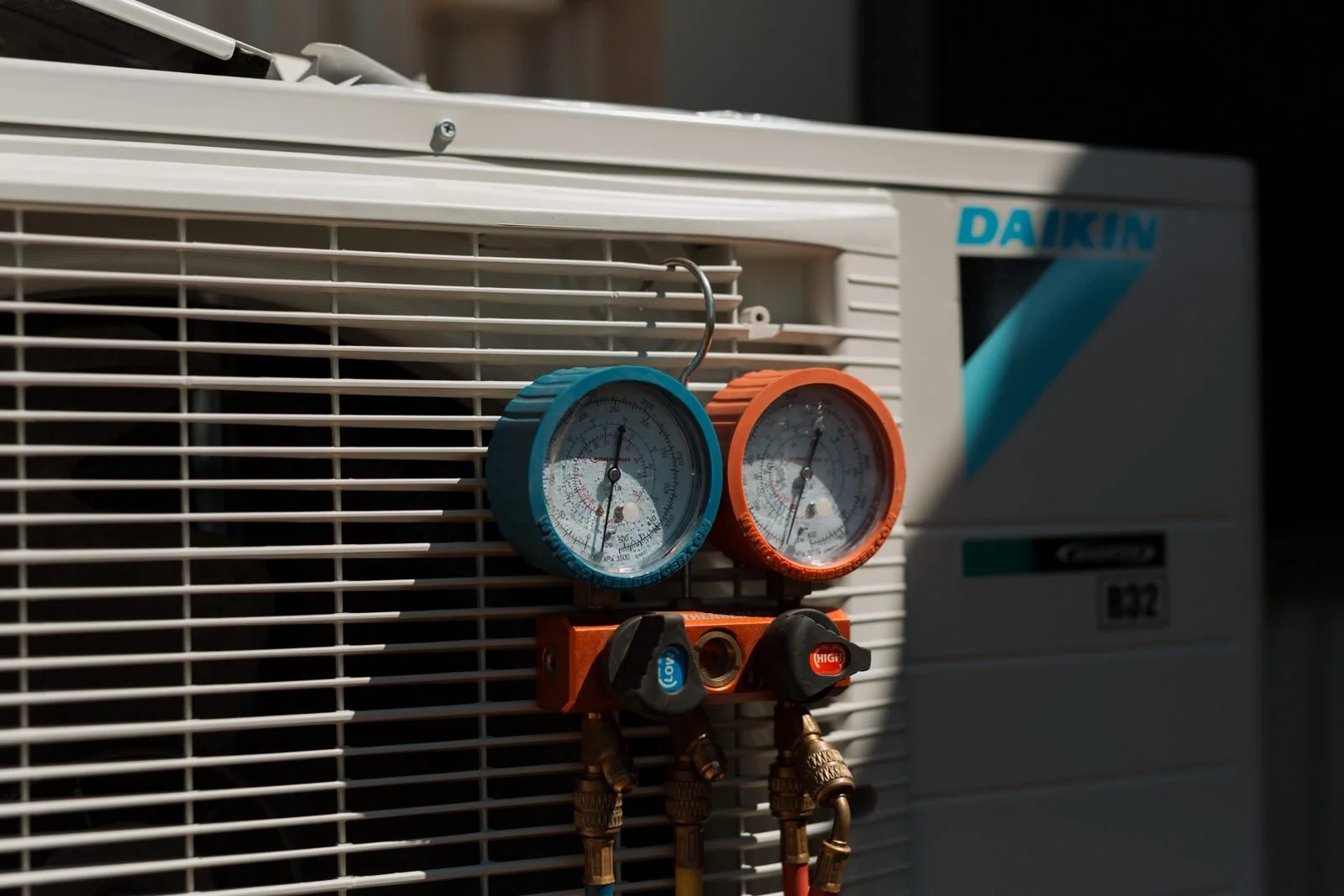 Refrigerant gauges connected to a condensing unit