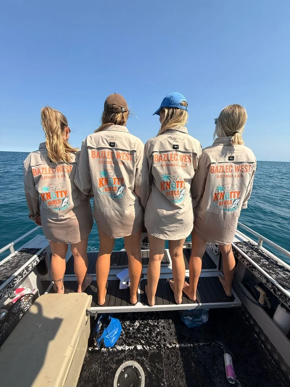 The Bazlec West Knotty Girls in branded fishing shirts out on the boat