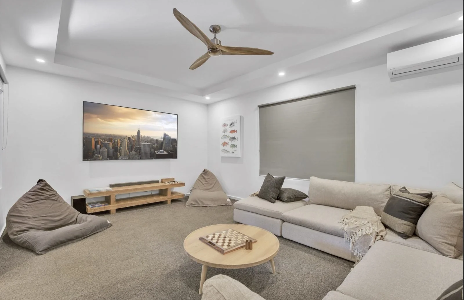 Media room with wall-mounted TV, ceiling fan and downlights